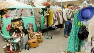 Open camper van with vintage items for sale